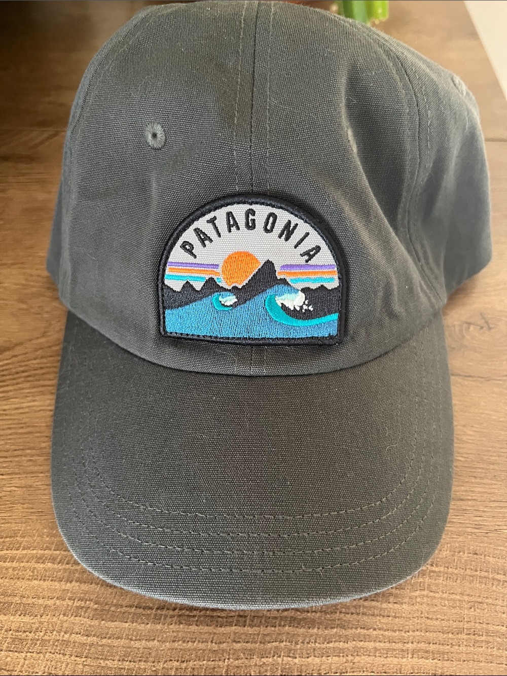 Patagonia Black Cap with Teal Waves and Orange Sun Patch